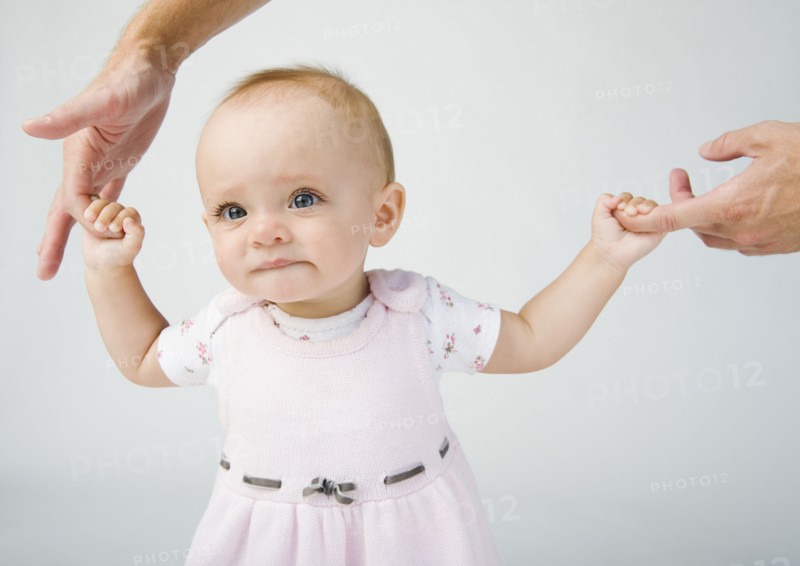 Baby holding father`s fingers. Photo. Erik Isakson