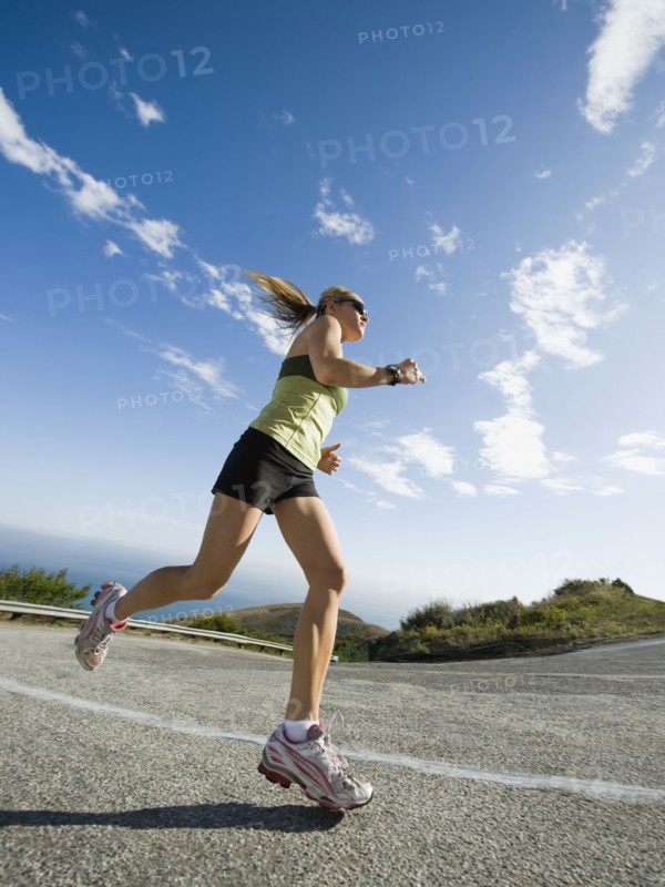 Woman running on a road in Malibu. Photo. Erik Isakson