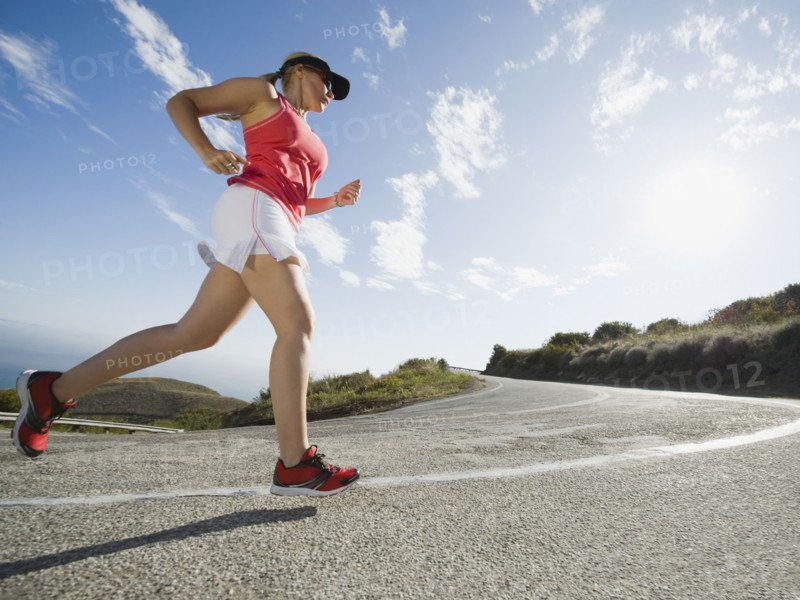 Woman running on a road in Malibu. Photo. Erik Isakson