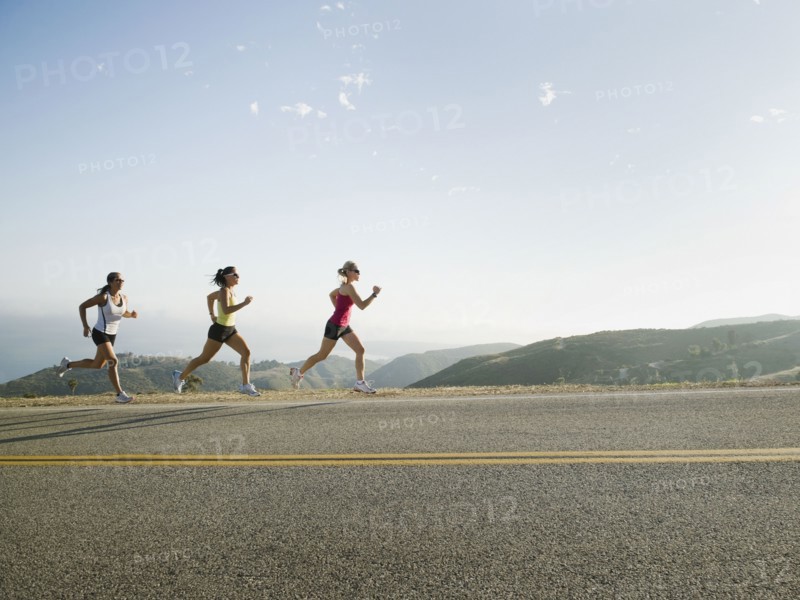 Runners training on side of a road. Photo. Erik Isakson