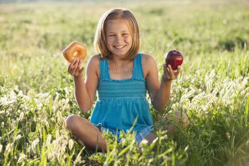 Young girl making food choice. Photo. Mike Kemp