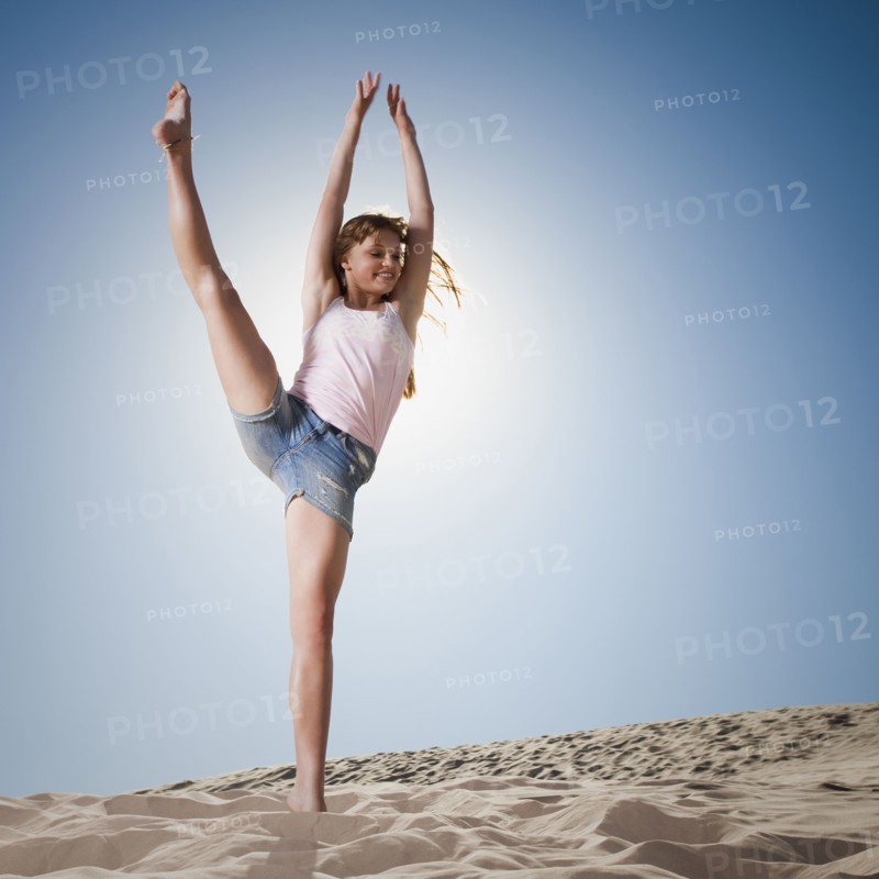 Woman dancing in sand. Photo. Mike Kemp