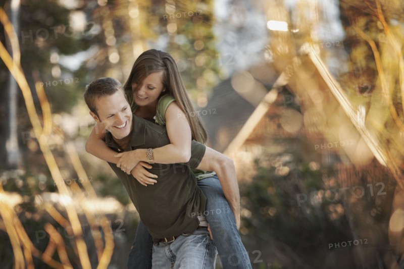 Man giving girlfriend a piggyback ride. Photo. FBP
