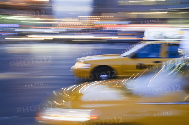 Taxi cabs driving at night. Photo : Antonio M. Rosario