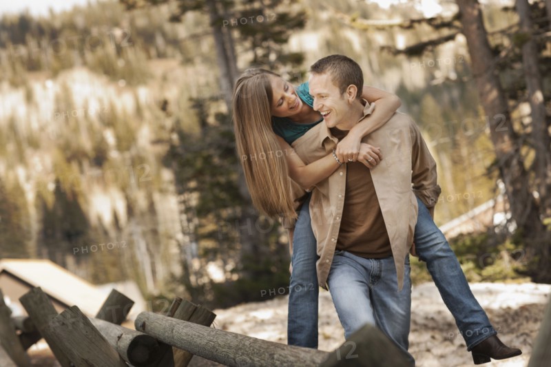 Man giving girlfriend a piggyback ride. Photo. FBP