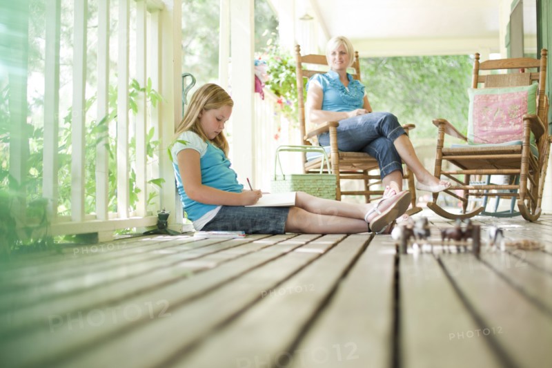 Mother and daughter relaxing on porch. Photo. Tim Pannell