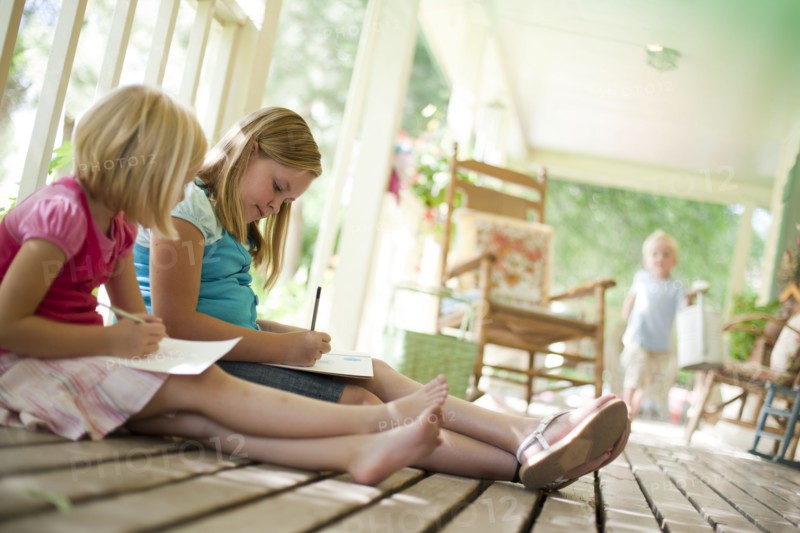 Two girls writing letters. Photo. Tim Pannell