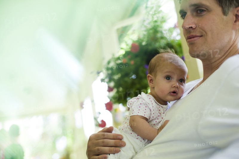 Father and baby daughter sitting on porch. Photo. Tim Pannell