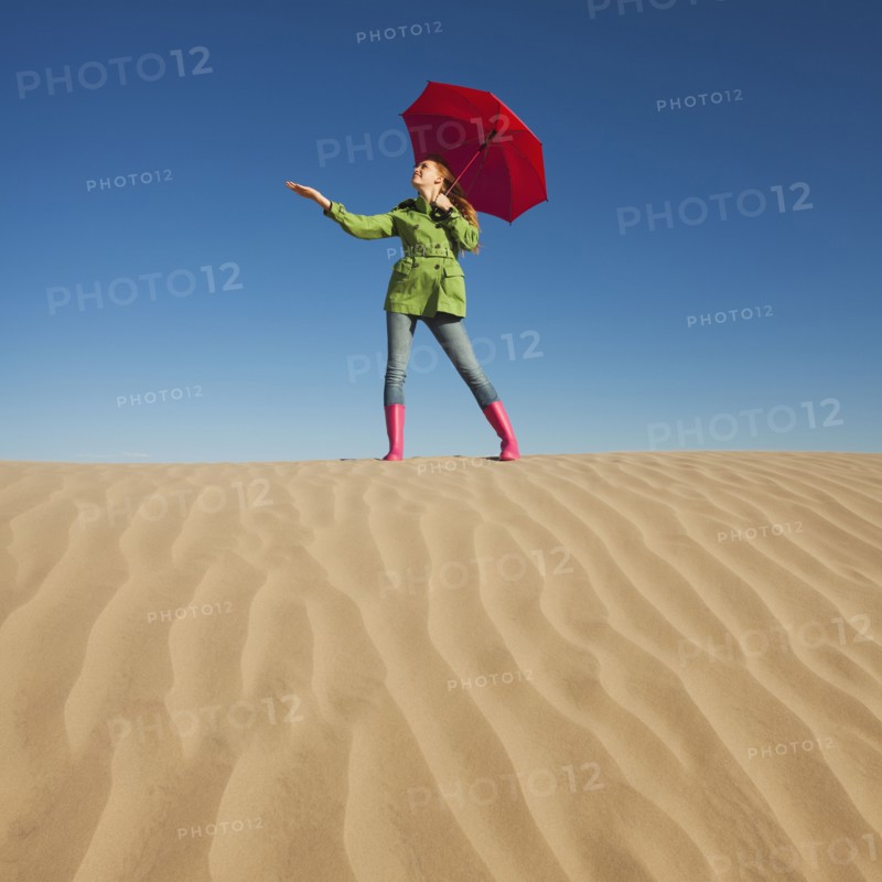 Woman waiting for rain in the desert. Photo. Mike Kemp