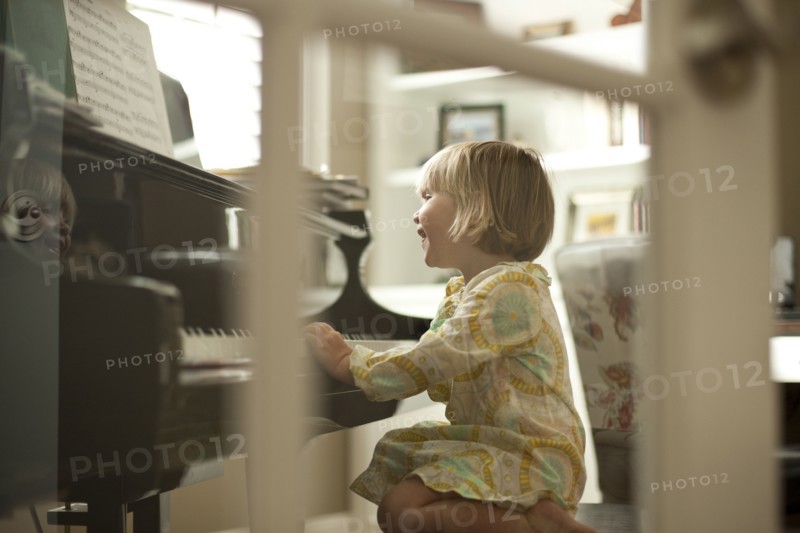 Young girl playing piano. Photo. Tim Pannell