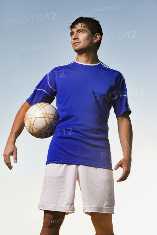 Soccer player holding ball. Photo : Mike Kemp
