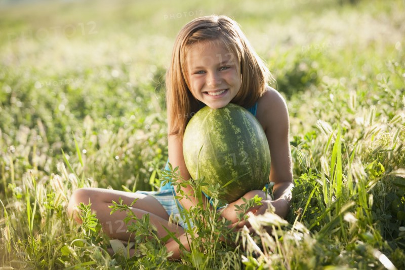 Young girl holding a watermelon. Photo. Mike Kemp