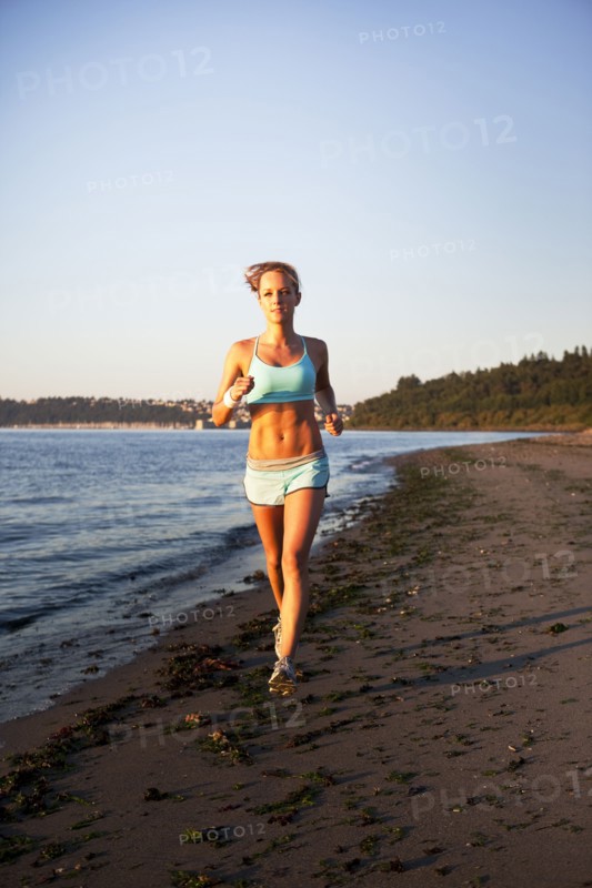 Woman running on the beach. Photo. Take A Pix Media