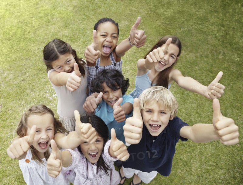 Group of children with their thumbs up. Photo. momentimages