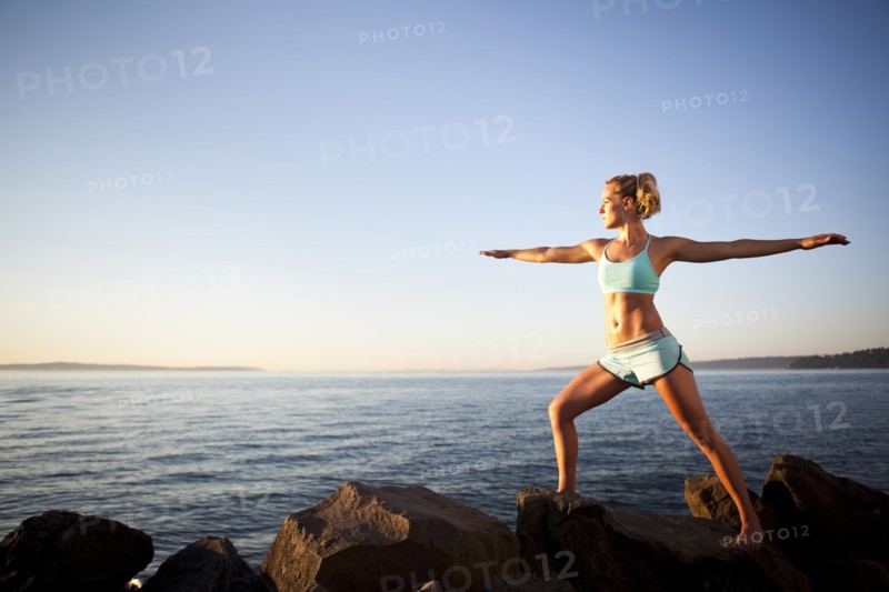 Athletic woman stretching outdoors. Photo : Take A Pix Media