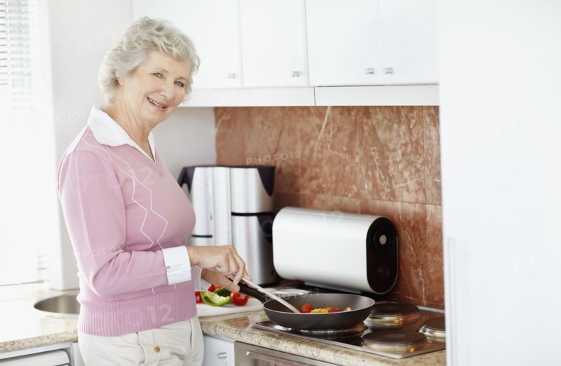 Senior woman cooking. Photo. momentimages