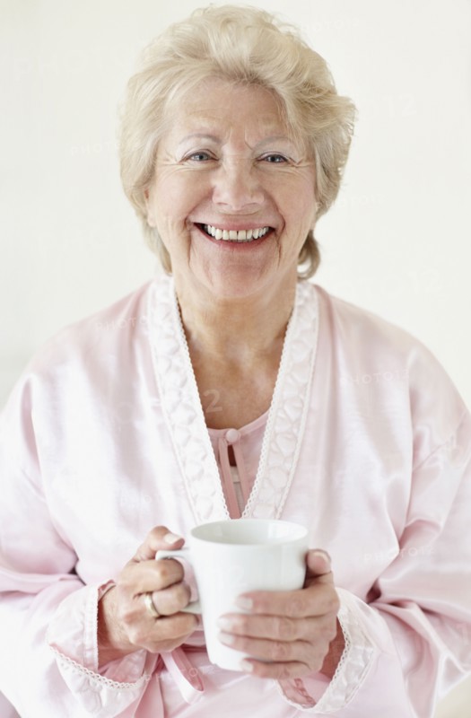 Senior woman wearing a bathrobe. Photo. momentimages
