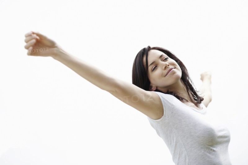 Carefree woman stretching. Photo. momentimages