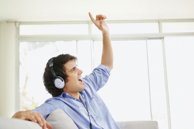 Man listening to music on headphones. Photo. momentimages