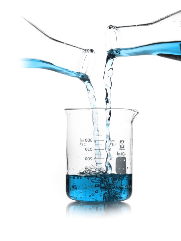 Blue liquid being poured into measuring cup. Photo : David Arky