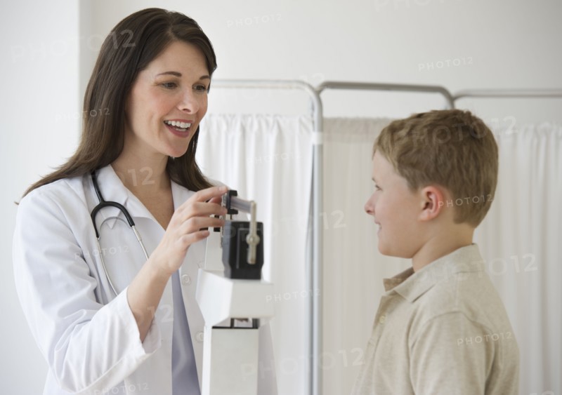Young boy and doctor in examination room.
