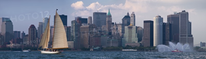 Sailboat on river in front of Lower Manhattan.