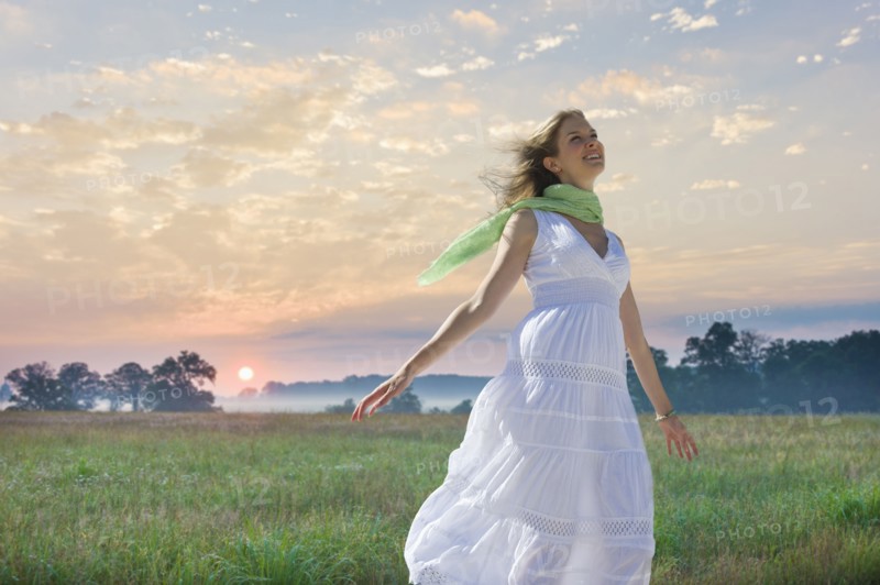 Carefree woman in field.