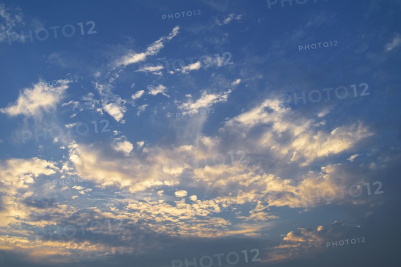 Clouds in blue sky at dusk.