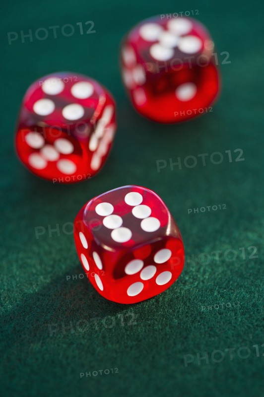 Red dice on green felt. Photo. Daniel Grill