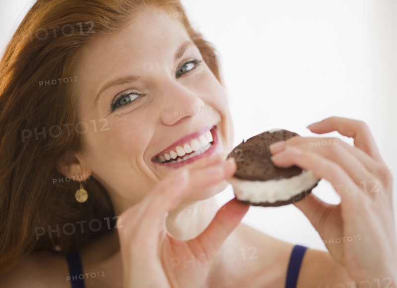 Woman eating an ice cream sandwich. Photo. Jamie Grill