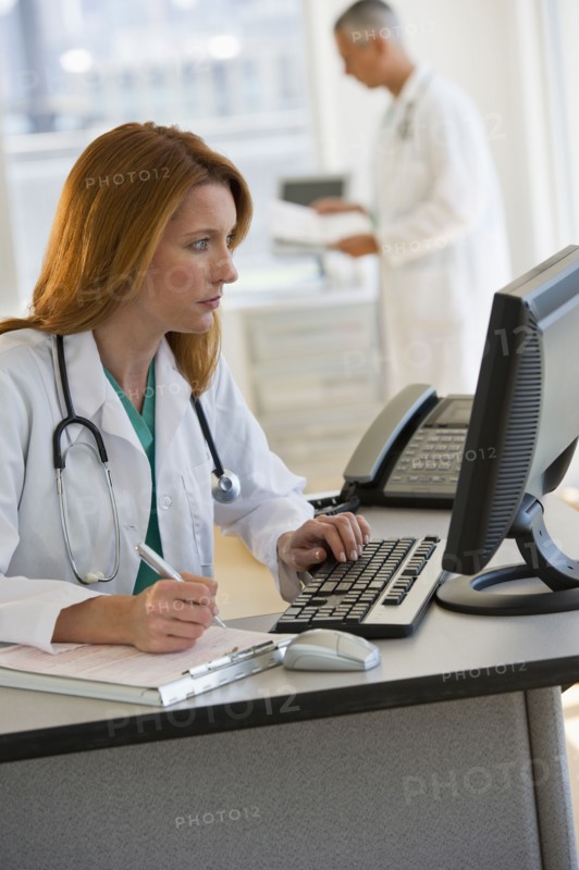 Doctor working on computer.