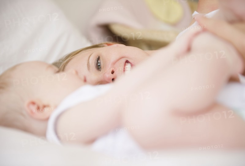 Mother and baby lying down together. Photo : Jamie Grill
