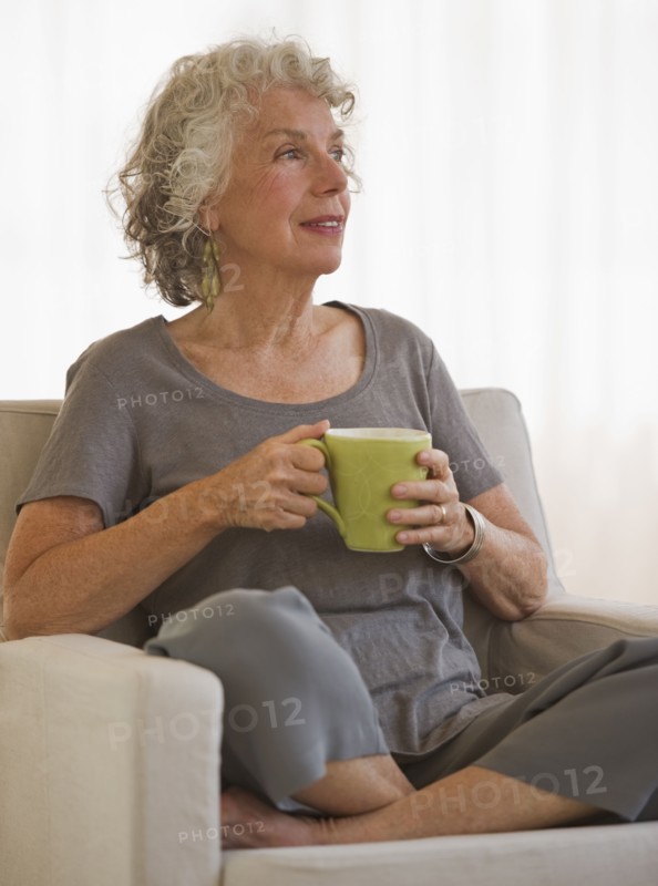 Woman drinking a cup of coffee. Photo. Daniel Grill