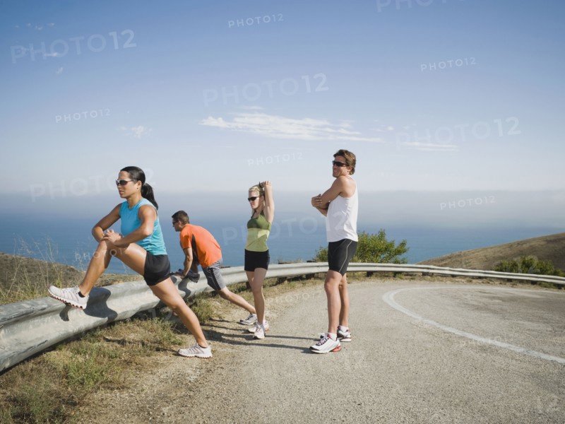Runners stretching on the side of the road. Photo. Erik Isakson