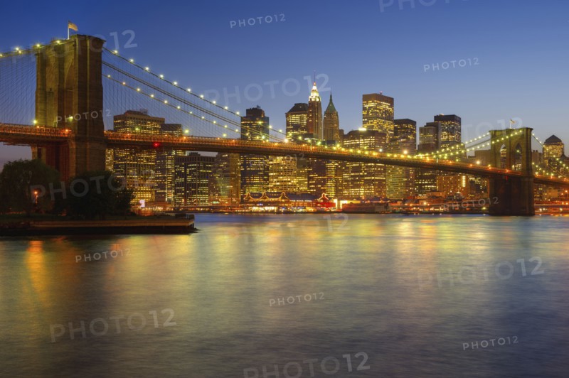 Brooklyn Bridge and Jersey City buildings at night. Photo. Daniel Grill
