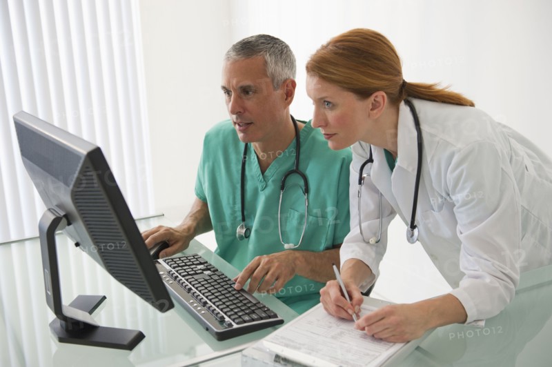 Healthcare professionals looking at computer.