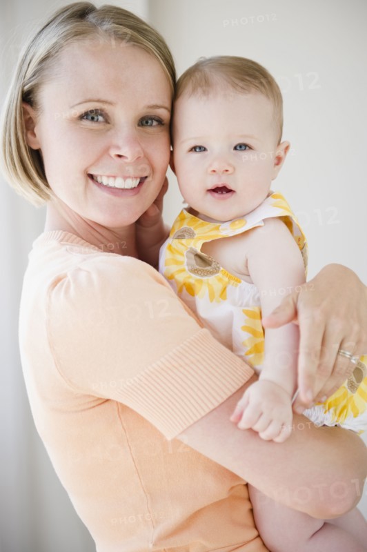 Mother holding her baby daughter. Photo. Jamie Grill
