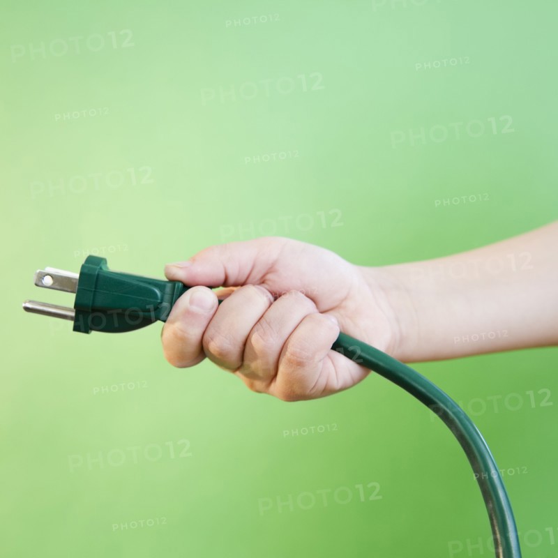 Hand holding electrical cord. Photo. Jamie Grill