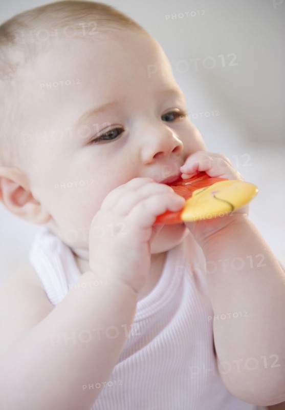 Baby sucking on teething toy. Photo. Jamie Grill