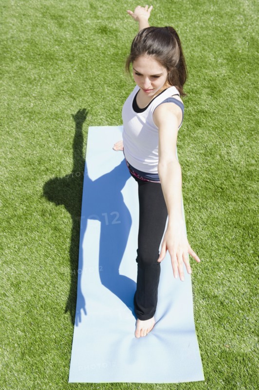 Woman doing yoga outside. Photo. Jamie Grill