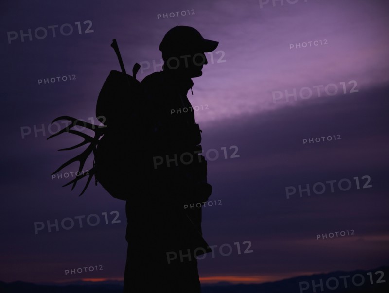 Hunter with deer antler in his backpack. Photo. Mike Kemp