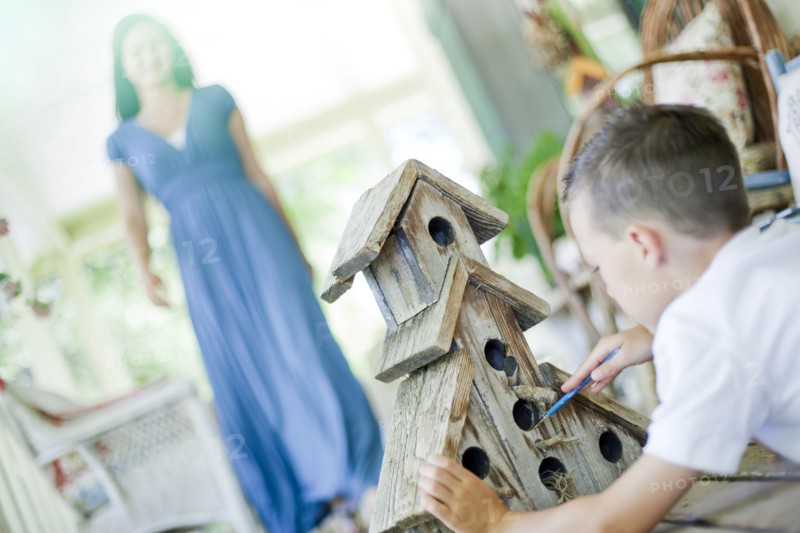 Young boy painting a birdhouse. Photo. Tim Pannell