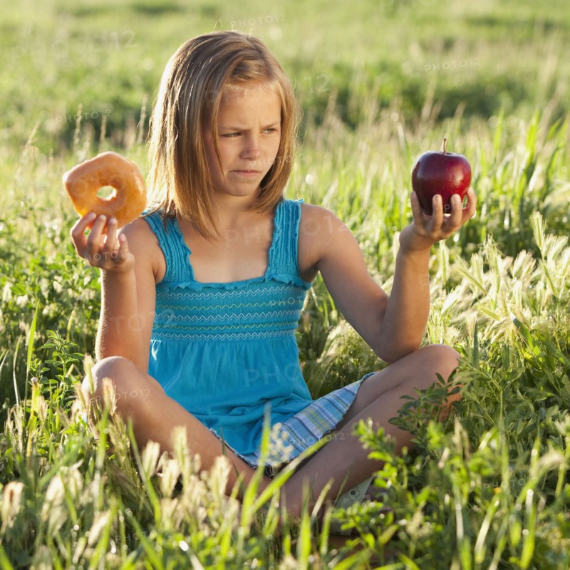 Young girl making food choice. Photo. Mike Kemp