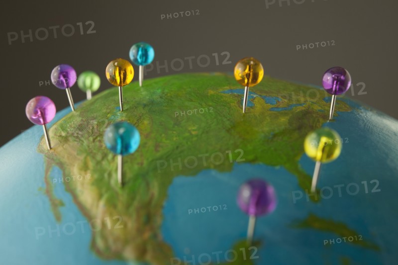Push pins on globe. Photo. Mike Kemp