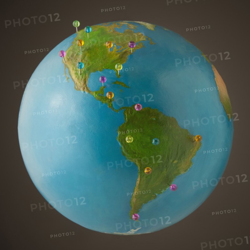 Push pins on globe. Photo. Mike Kemp