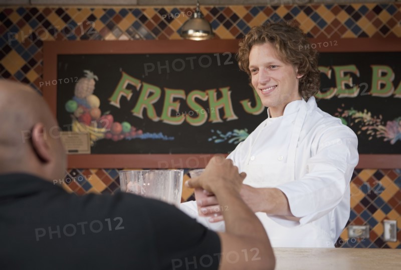 Bartender and customer at juice bar. Photo. Dan Bannister