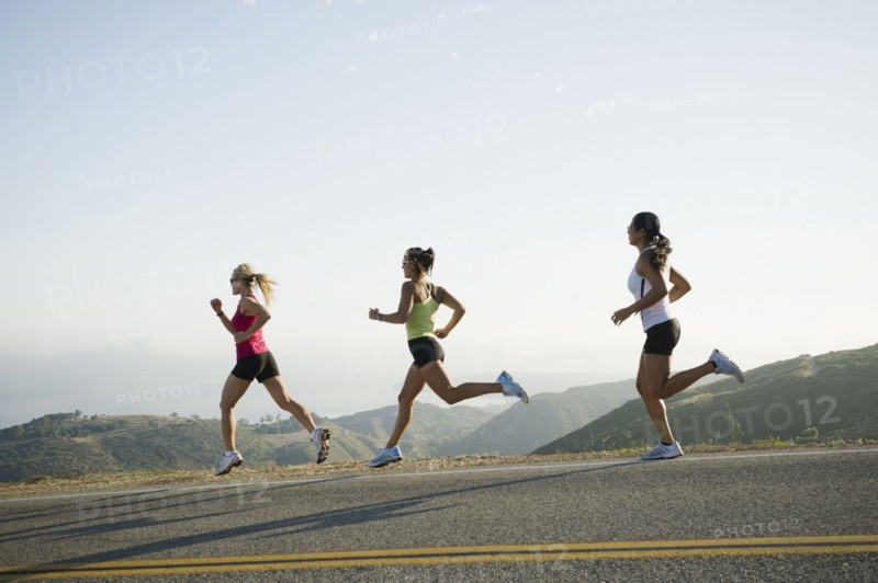 Runners training on side of a road. Photo. Erik Isakson