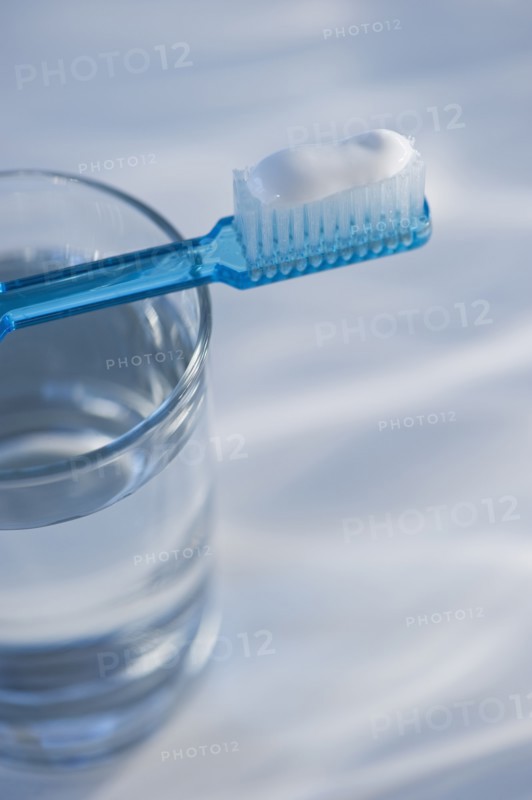 Toothbrush and glass of water. Photo. Daniel Grill