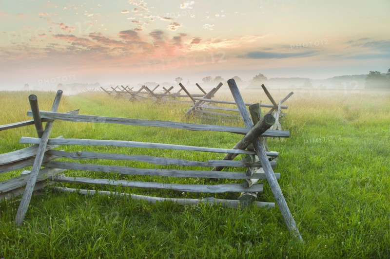 Rustic fence in field.