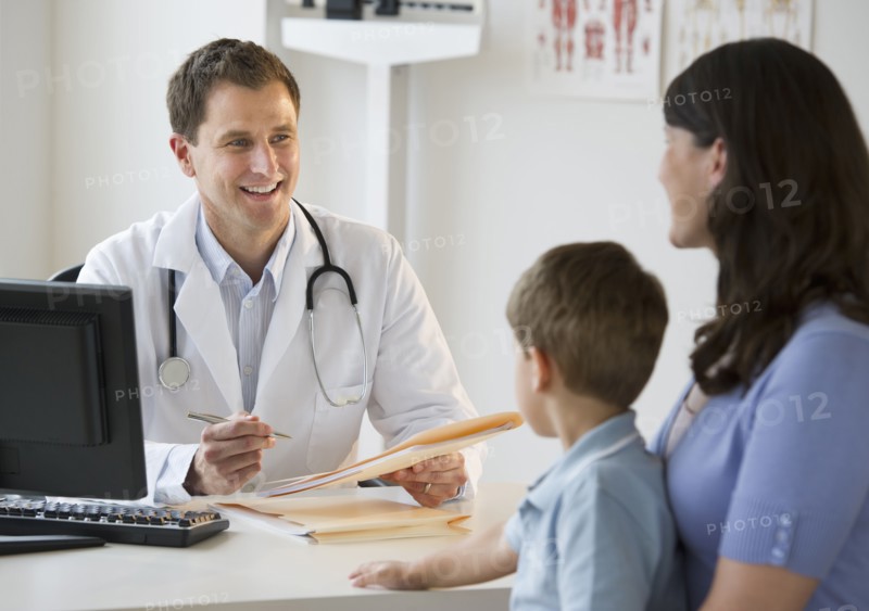 Doctor talking to woman and her son.